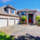 Large modern house with three garage spaces and concrete drivewa